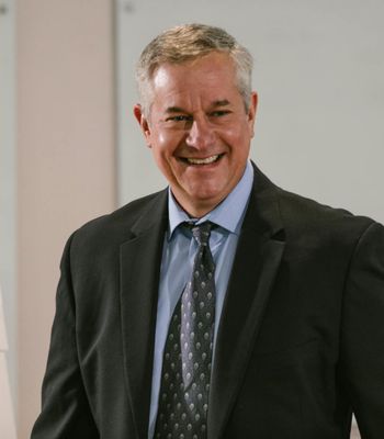 Man in business suit smiling confidently