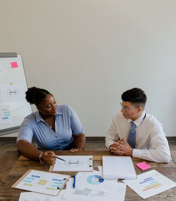 Man presenting on whiteboard to team