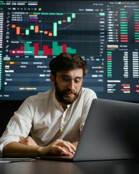 Man reviewing investment analytics on tablet